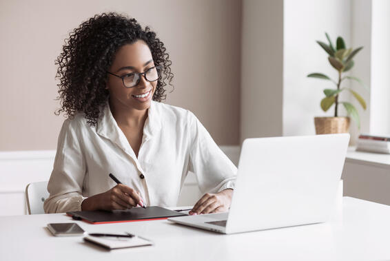 Woman working from home. Student girl using laptop in her room